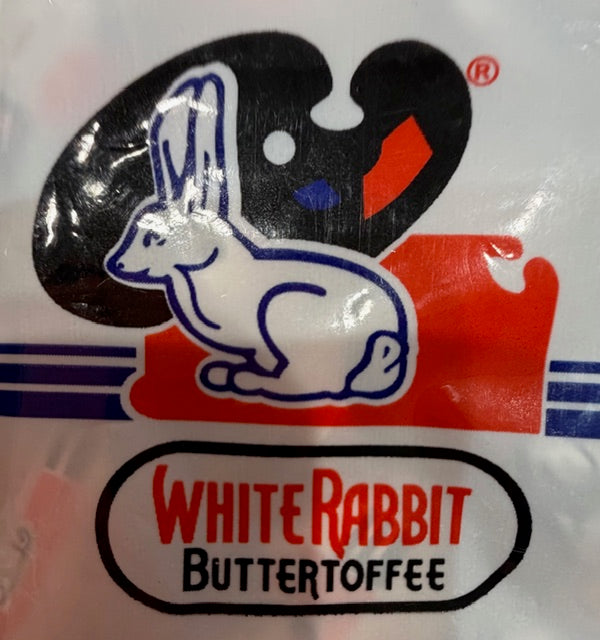 White Rabbit Buttertoffee candy packaging featuring the classic white rabbit logo against a black and red background, with the text 'WHITE RABBIT BUTTERTOFFEE' at the bottom.