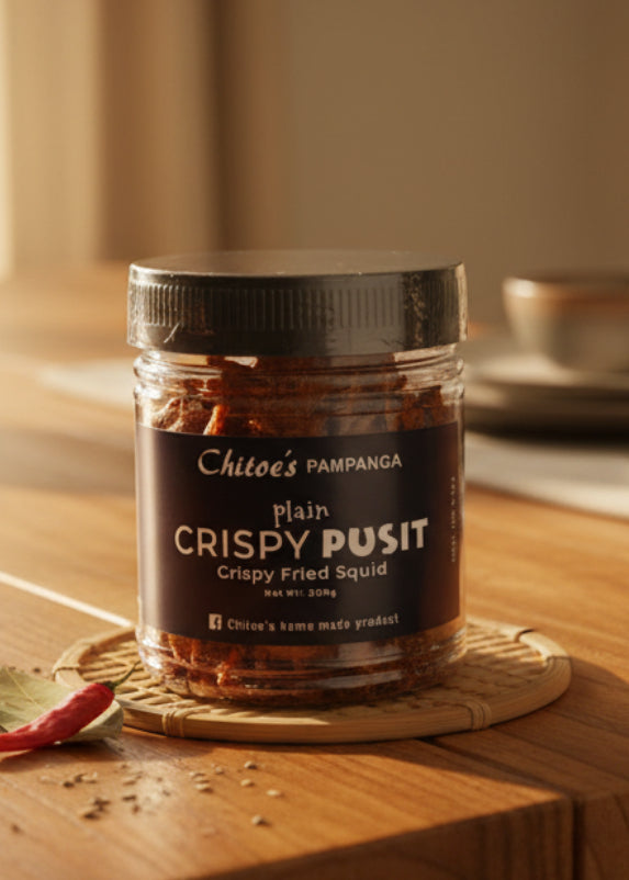 A clear plastic jar of Chitoe's Pampanga Plain Crispy Pusit (Crispy Fried Squid) with a black lid and a dark navy label, set against a plain white background.